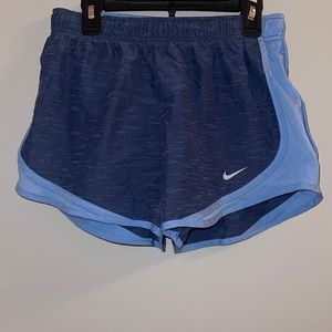 lightly worn dri-fit nike shorts in navy and light blue.